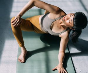 Serenity and mental health: Asian woman stretches in yoga pose.